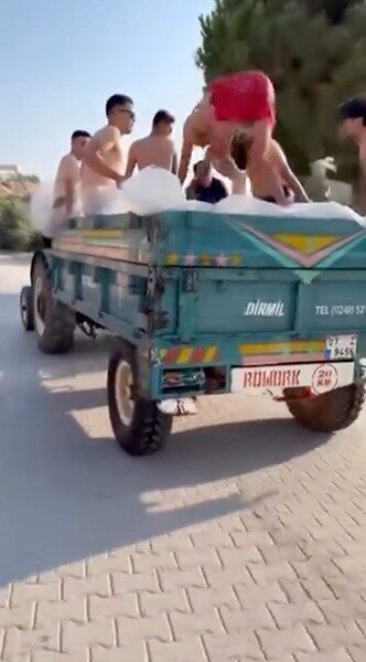 Antalya’nın Demre ilçesinde bir grup gencin mobil havuza çevrilen traktör