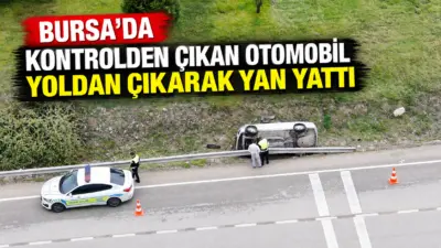 Bursa’da yağış sebebiyle sürücüsünün kontrolünden çıkan otomobil yan yattı. Kazada